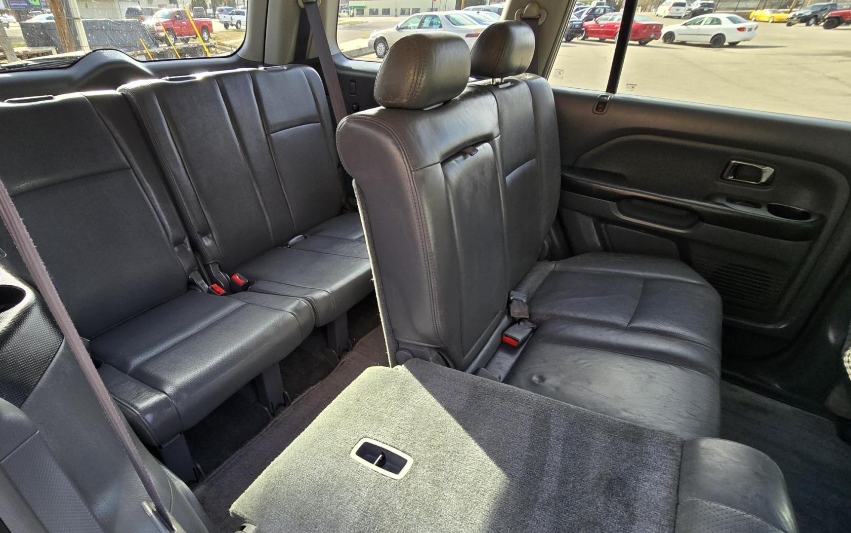 2004 Blue /Black Honda Pilot EX w/ Leather and DVD (2HKYF18664H) with an 3.5L V6 SOHC 24V engine, 5-Speed Automatic Overdrive transmission, located at 450 N Russell, Missoula, MT, 59801, (406) 543-6600, 46.874496, -114.017433 - Great Running AWD Honda. 3.5L V6 Engine. 3rd Row Seating. Heated Front Seats. Power Drivers Seat. Rear Entertainment. Air. Cruise. Tilt. Power Windows and Locks. Remote Start. Has some rust and the front seats are worn. Has an Air Bag Light so we are selling AS-IS. Clean Title and Carfax. No Fina - Photo#9