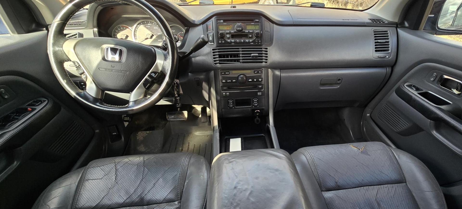 2004 Blue /Black Honda Pilot EX w/ Leather and DVD (2HKYF18664H) with an 3.5L V6 SOHC 24V engine, 5-Speed Automatic Overdrive transmission, located at 450 N Russell, Missoula, MT, 59801, (406) 543-6600, 46.874496, -114.017433 - Great Running AWD Honda. 3.5L V6 Engine. 3rd Row Seating. Heated Front Seats. Power Drivers Seat. Rear Entertainment. Air. Cruise. Tilt. Power Windows and Locks. Remote Start. Has some rust and the front seats are worn. Has an Air Bag Light so we are selling AS-IS. Clean Title and Carfax. No Fina - Photo#13