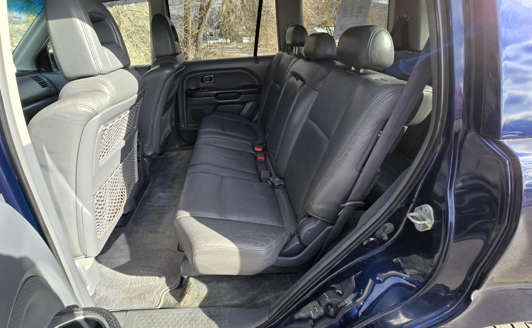 2004 Blue /Black Honda Pilot EX w/ Leather and DVD (2HKYF18664H) with an 3.5L V6 SOHC 24V engine, 5-Speed Automatic Overdrive transmission, located at 450 N Russell, Missoula, MT, 59801, (406) 543-6600, 46.874496, -114.017433 - Great Running AWD Honda. 3.5L V6 Engine. 3rd Row Seating. Heated Front Seats. Power Drivers Seat. Rear Entertainment. Air. Cruise. Tilt. Power Windows and Locks. Remote Start. Has some rust and the front seats are worn. Has an Air Bag Light so we are selling AS-IS. Clean Title and Carfax. No Fina - Photo#15