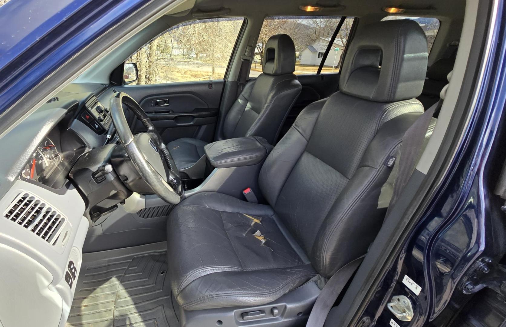 2004 Blue /Black Honda Pilot EX w/ Leather and DVD (2HKYF18664H) with an 3.5L V6 SOHC 24V engine, 5-Speed Automatic Overdrive transmission, located at 450 N Russell, Missoula, MT, 59801, (406) 543-6600, 46.874496, -114.017433 - Great Running AWD Honda. 3.5L V6 Engine. 3rd Row Seating. Heated Front Seats. Power Drivers Seat. Rear Entertainment. Air. Cruise. Tilt. Power Windows and Locks. Remote Start. Has some rust and the front seats are worn. Has an Air Bag Light so we are selling AS-IS. Clean Title and Carfax. No Fina - Photo#16