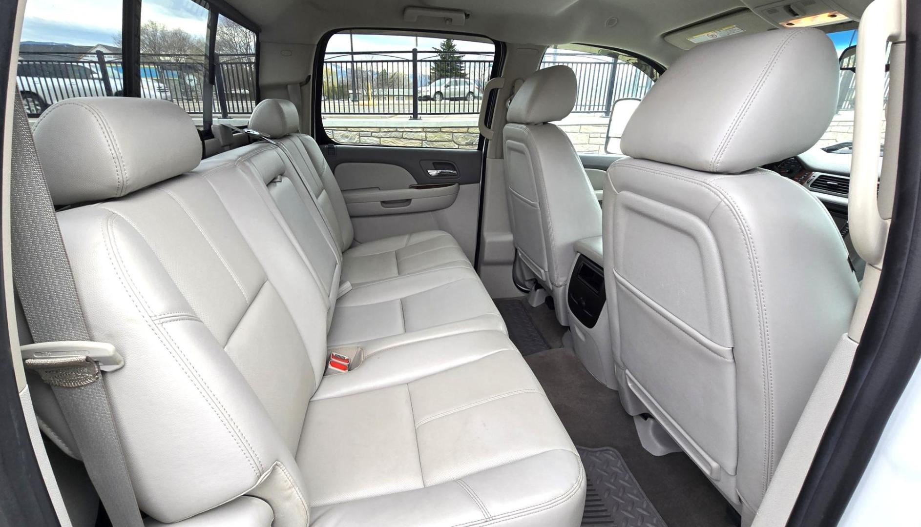 2013 White /Tan GMC Sierra 2500HD SLT Crew Cab 4WD (1GT121EG3DF) with an 6.0L V8 OHV 16V FFV engine, 6-Speed Automatic transmission, located at 450 N Russell, Missoula, MT, 59801, (406) 543-6600, 46.874496, -114.017433 - Very Clean 3/4 Ton 4WD Crewcab. Beefy 6.0L V8 Engine. 6 Speed Automatic Transmission. Power Heated Front Seats. Leather Seats. Navigation. Bluetooth Audio and Phone. AM FM CD Player. Backup Camera. Air. cruise. Tilt. Power Windows and Locks. Remote Start. Nice Custom Wheels. Grill Guard. Running Boa - Photo#10