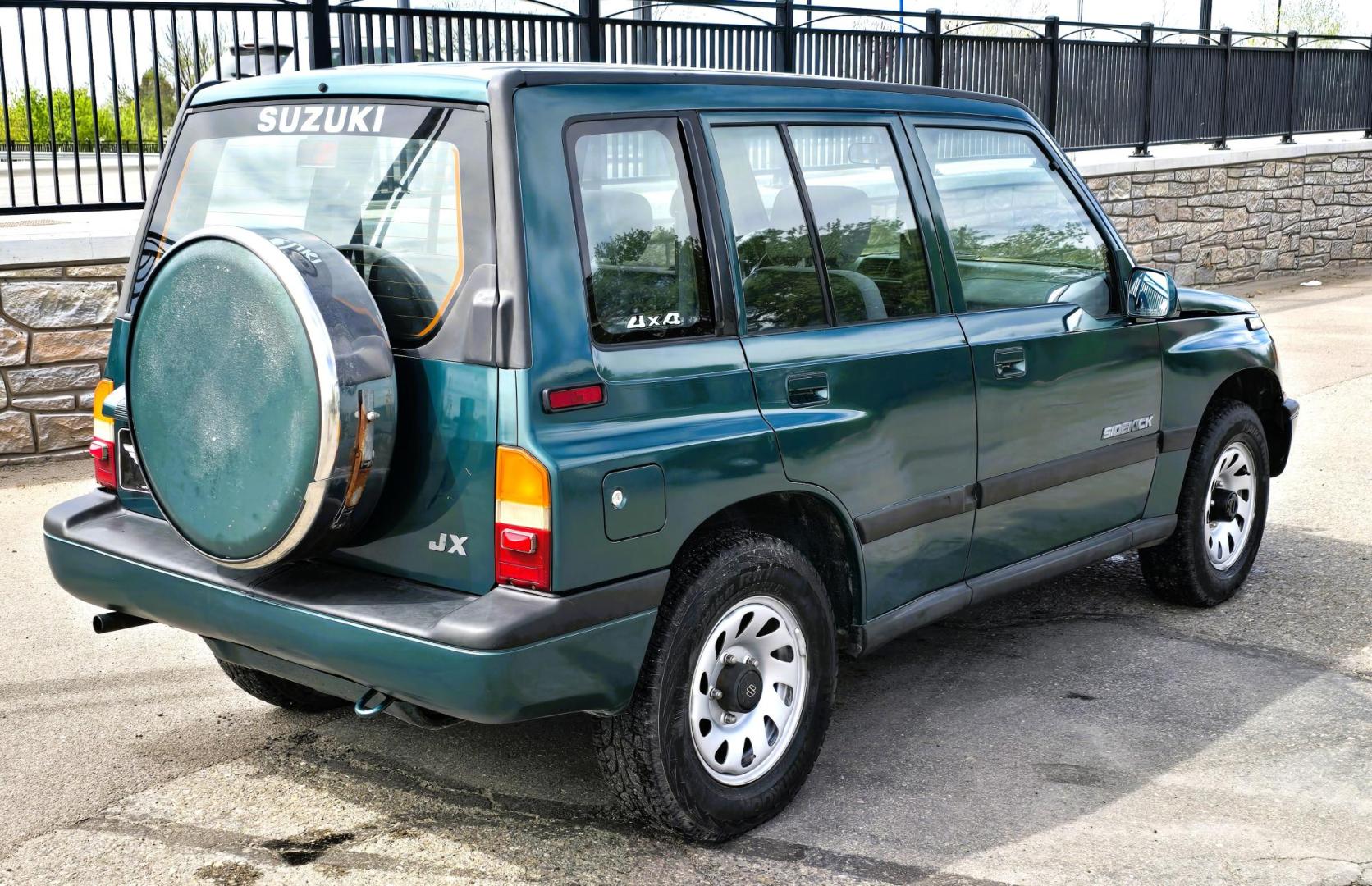 1997 Green Suzuki Sidekick JX 4-Door 4WD (2S3TD03V7V6) with an 1.6L L4 SOHC 16V engine, 5 Speed Manual transmission, located at 450 N Russell, Missoula, MT, 59801, (406) 543-6600, 46.874496, -114.017433 - Photo#2