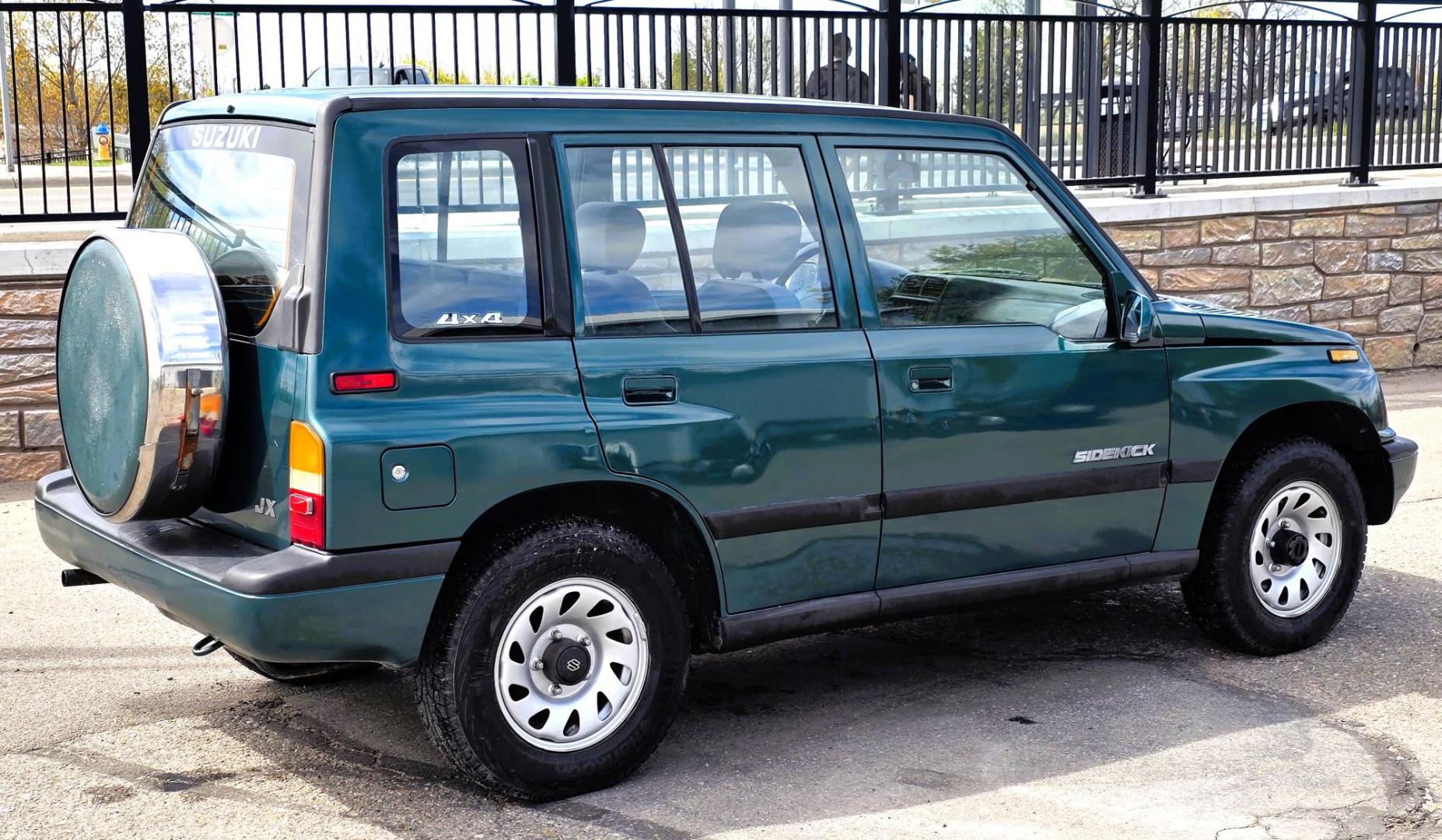 1997 Green Suzuki Sidekick JX 4-Door 4WD (2S3TD03V7V6) with an 1.6L L4 SOHC 16V engine, 5 Speed Manual transmission, located at 450 N Russell, Missoula, MT, 59801, (406) 543-6600, 46.874496, -114.017433 - Photo#1