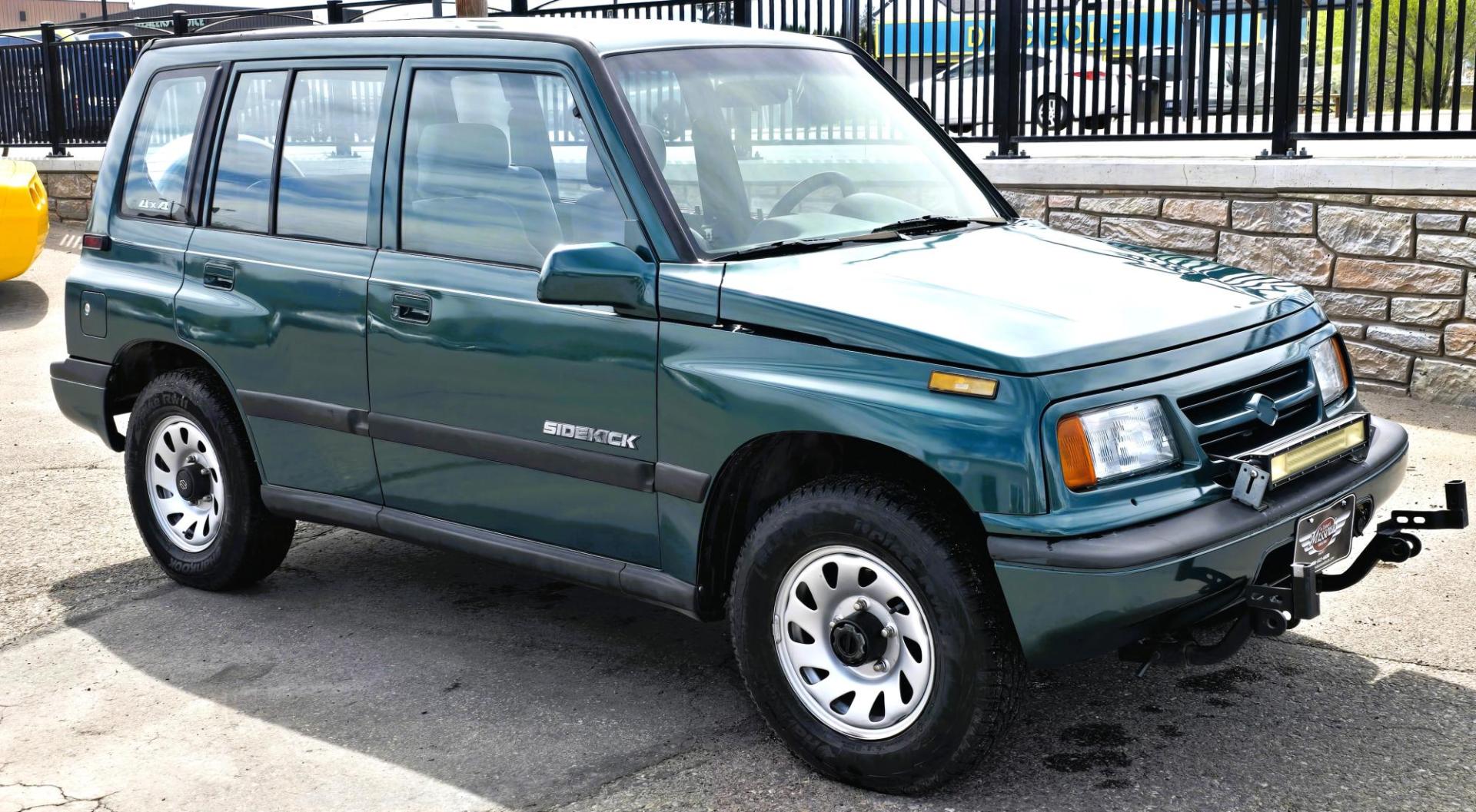 1997 Green Suzuki Sidekick JX 4-Door 4WD (2S3TD03V7V6) with an 1.6L L4 SOHC 16V engine, 5 Speed Manual transmission, located at 450 N Russell, Missoula, MT, 59801, (406) 543-6600, 46.874496, -114.017433 - Photo#4