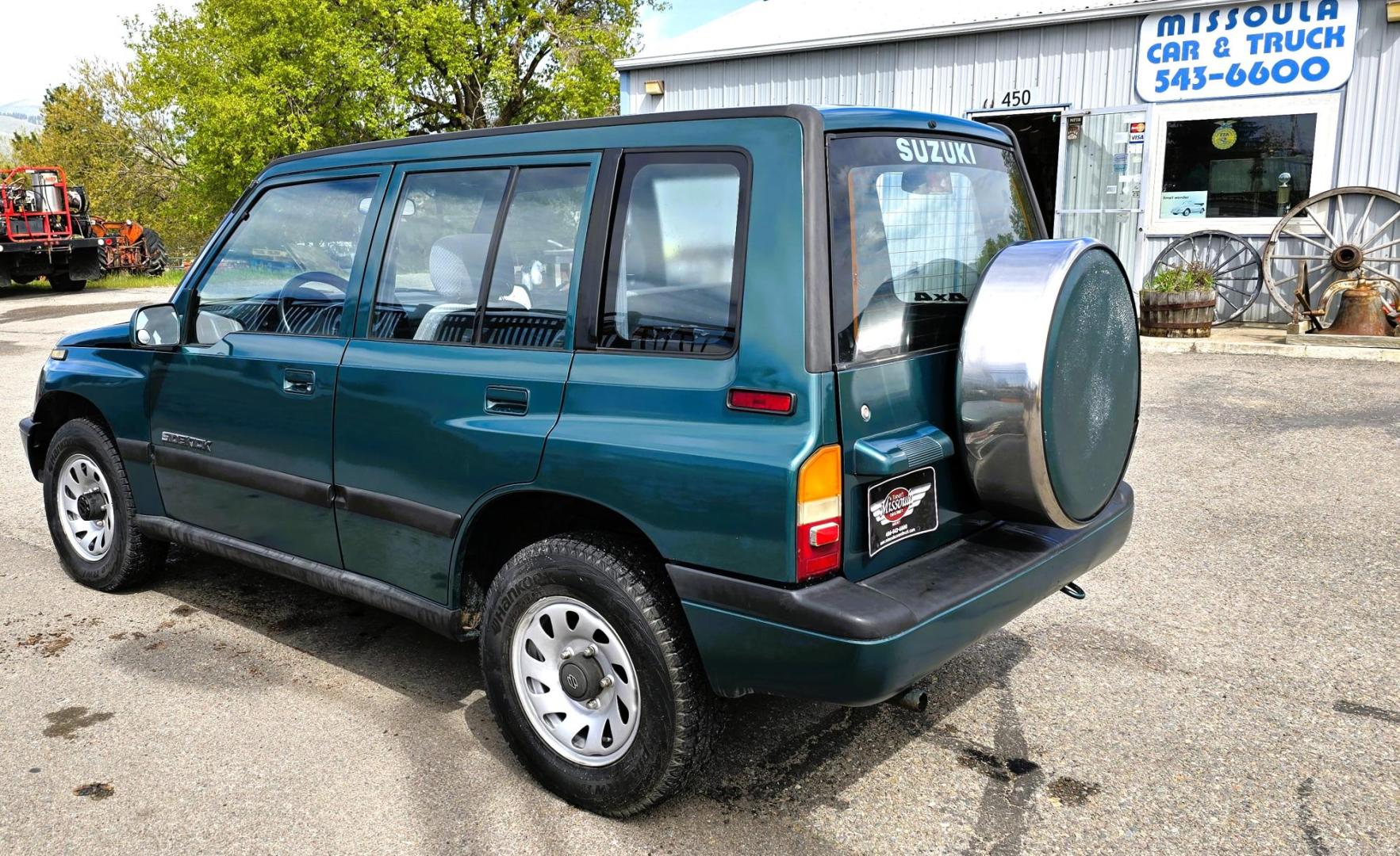 1997 Green Suzuki Sidekick JX 4-Door 4WD (2S3TD03V7V6) with an 1.6L L4 SOHC 16V engine, 5 Speed Manual transmission, located at 450 N Russell, Missoula, MT, 59801, (406) 543-6600, 46.874496, -114.017433 - Photo#8