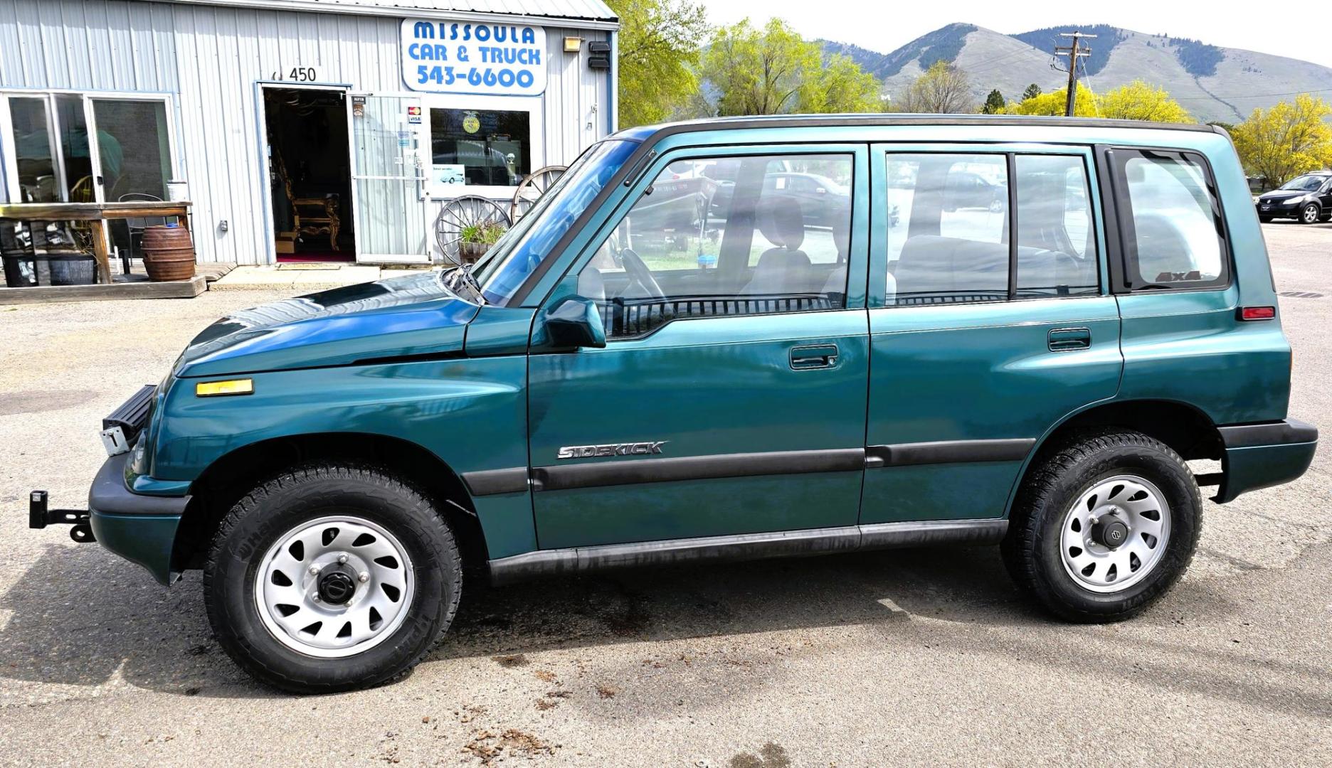1997 Green Suzuki Sidekick JX 4-Door 4WD (2S3TD03V7V6) with an 1.6L L4 SOHC 16V engine, 5 Speed Manual transmission, located at 450 N Russell, Missoula, MT, 59801, (406) 543-6600, 46.874496, -114.017433 - Photo#7