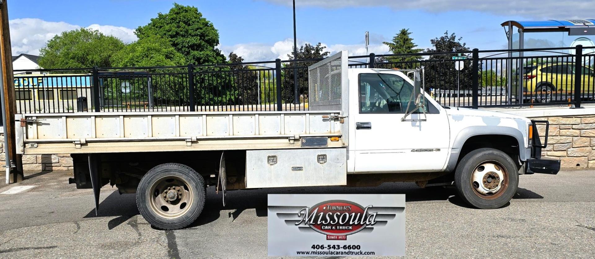 2000 White /Blue Chevrolet C/K 3500 Reg. Cab 2WD (1GBKC34J4YF) with an 7.4L V8 OHV 16V engine, Automatic transmission, located at 450 N Russell, Missoula, MT, 59801, (406) 543-6600, 46.874496, -114.017433 - Beefy One Ton Chevy Dually with the Powerful 7.4L V8 Engine. Automatic Transmission. Rear Wheel Drive. Massive Aluminum Flatbed measuring 8 Feet Wide by just under 12 feet long. Hydraulic Lift raises the Flatbed almost vertical. Air Conditioning. Blows Cold. AM FM Radio. Dual Gas Tanks. Not a lot of - Photo#1