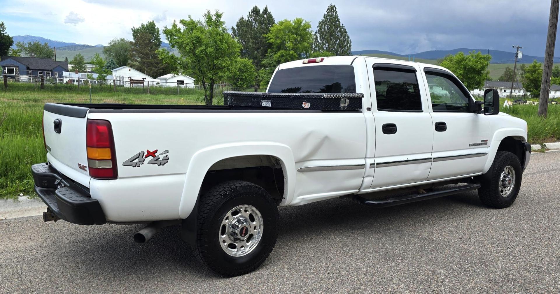 2002 White /Black GMC Sierra 2500HD SL Crew Cab Long Bed 4WD (1GTHK23192F) with an 6.6L V8 OHV 32V TURBO DIESEL engine, Automatic transmission, located at 450 N Russell, Missoula, MT, 59801, (406) 543-6600, 46.874496, -114.017433 - Discount Special. PLEASE READ! Strong running 6.6L Duramax Diesel V8 Engine. Automatic Transmission. Long Bed. 4WD. Transmission works fine as does the Four Wheel Drive. Has good Tires. AM FM Stereo. Power Windows and Locks. Does need some work, but the price reflects that. Has a power steering lea - Photo#1