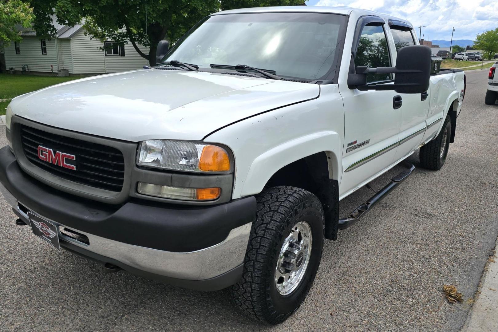 2002 White /Black GMC Sierra 2500HD SL Crew Cab Long Bed 4WD (1GTHK23192F) with an 6.6L V8 OHV 32V TURBO DIESEL engine, Automatic transmission, located at 450 N Russell, Missoula, MT, 59801, (406) 543-6600, 46.874496, -114.017433 - Discount Special. PLEASE READ! Strong running 6.6L Duramax Diesel V8 Engine. Automatic Transmission. Long Bed. 4WD. Transmission works fine as does the Four Wheel Drive. Has good Tires. AM FM Stereo. Power Windows and Locks. Does need some work, but the price reflects that. Has a power steering lea - Photo#3