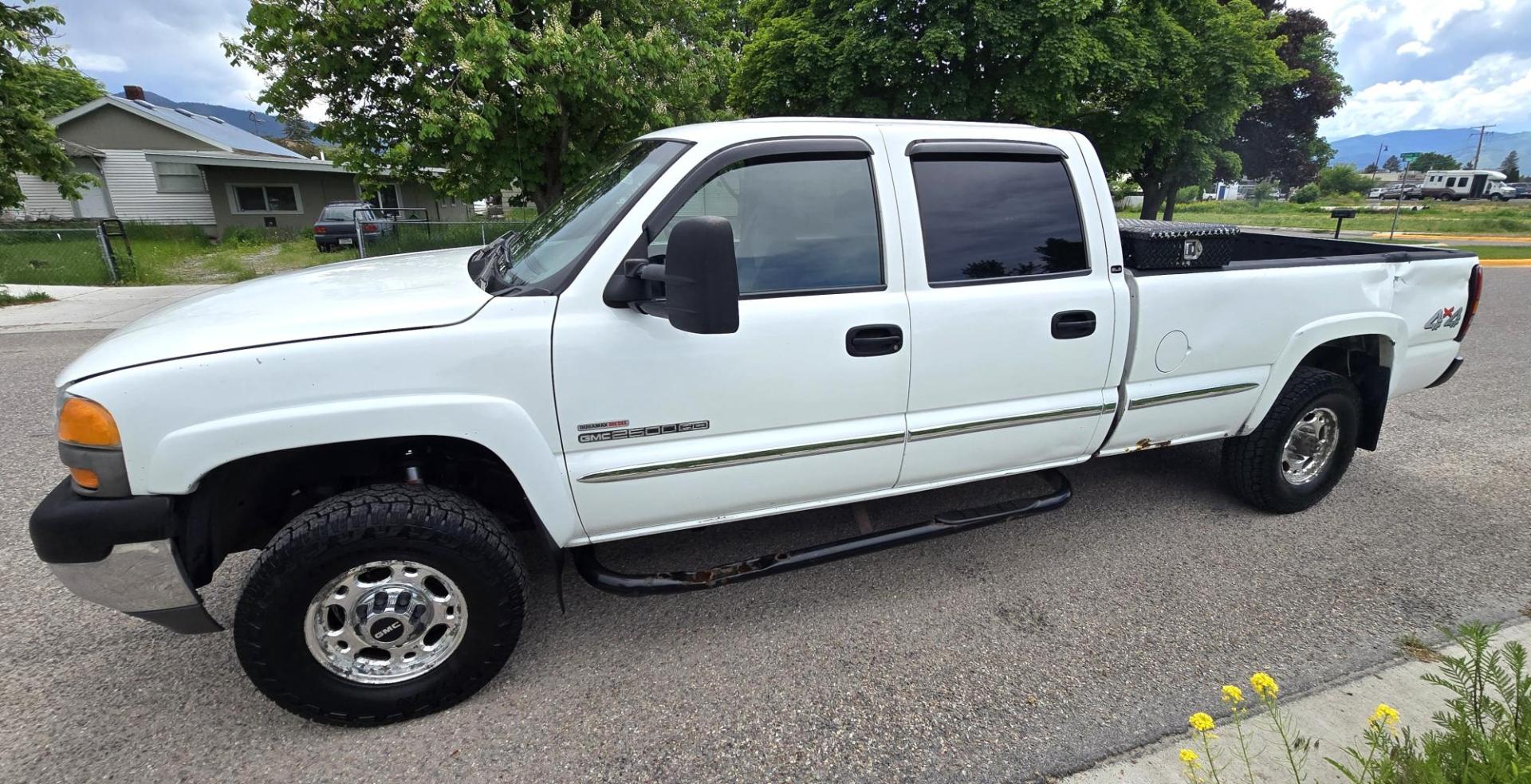 2002 White /Black GMC Sierra 2500HD SL Crew Cab Long Bed 4WD (1GTHK23192F) with an 6.6L V8 OHV 32V TURBO DIESEL engine, Automatic transmission, located at 450 N Russell, Missoula, MT, 59801, (406) 543-6600, 46.874496, -114.017433 - Discount Special. PLEASE READ! Strong running 6.6L Duramax Diesel V8 Engine. Automatic Transmission. Long Bed. 4WD. Transmission works fine as does the Four Wheel Drive. Has good Tires. AM FM Stereo. Power Windows and Locks. Does need some work, but the price reflects that. Has a power steering lea - Photo#4