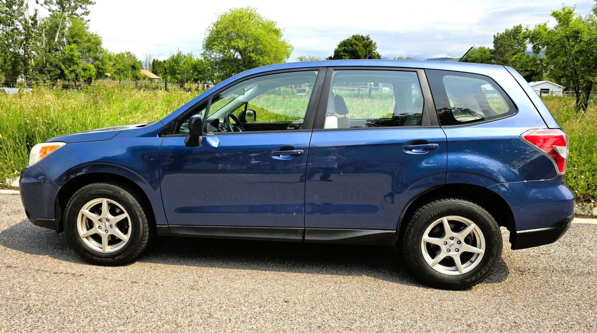 2014 Blue /White Subaru Forester 2.5i (JF2SJAAC6EH) with an 2.5L H4 SOHC 16V engine, 6-Speed Automatic transmission, located at 450 N Russell, Missoula, MT, 59801, (406) 543-6600, 46.874496, -114.017433 - Patriotic Blue 2 Owner Subaru with a clean Title and Carfax. 2.5L I4 Engine. Automatic Transmission. Air Conditioning. Cruise Control. Power Windows and Locks. AM FM CD Player. Bluetooth Audio and Phone Connection. Tires are in Very Good Condition. We Finance through local Credit Unions. We do N- Photo#9