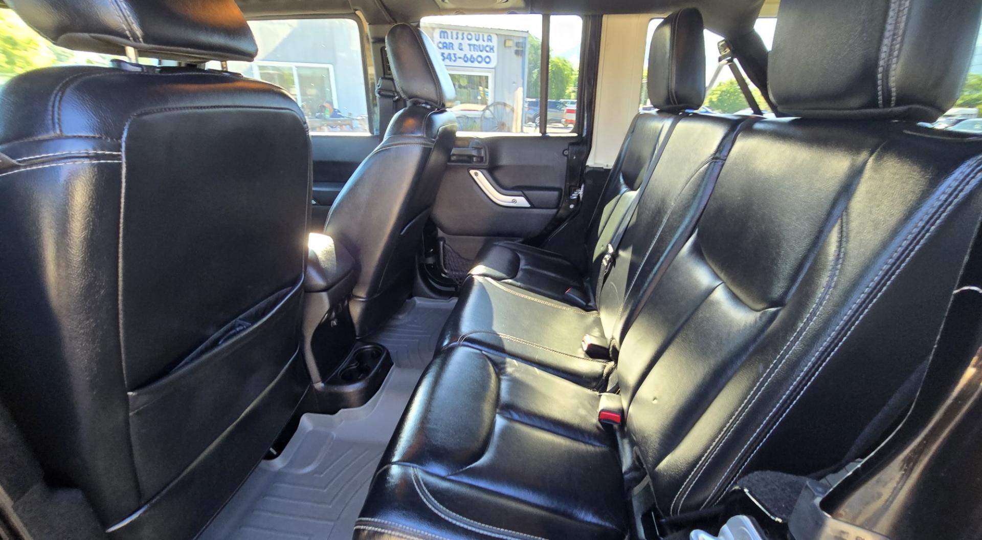 2013 Black /Black Jeep Wrangler Unlimited Rubicon 4WD (1C4HJWFG2DL) with an 3.6L V6 DOHC 24V FFV engine, Automatic transmission, located at 450 N Russell, Missoula, MT, 59801, (406) 543-6600, 46.874496, -114.017433 - Ready for Off-Road or a Classy Date on the town. 2013 Jeep Rubicon 4WD. 4 Door with a Hardtop. 3.6L V6 Engine. Automatic Transmission. Heated Front Seats. Nice Aftermarket Wheels. 8K Lb Winch in on Heavy Duty Front Bumper. Air Conditioning. Touch Screen Stereo with Bluetooth Phone. Power Windows and- Photo#12