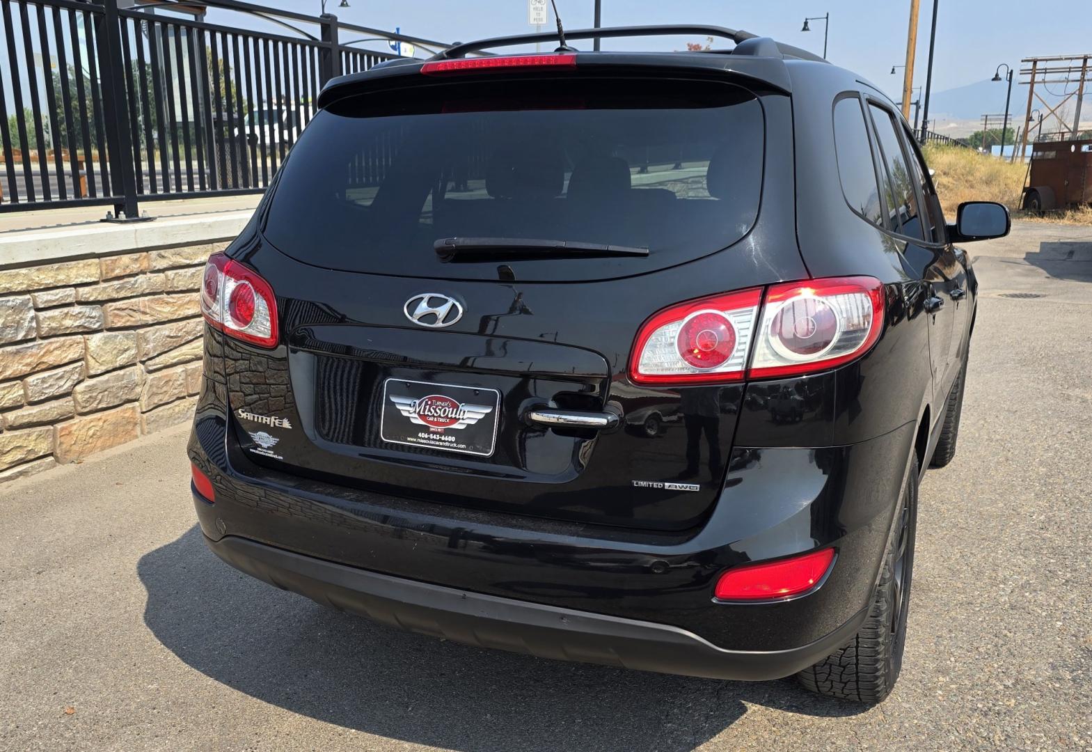 2012 Black /Black Hyundai Santa Fe Limited 3.5 4WD (5XYZKDAG4CG) with an 3.5L V6 DOHC 24V engine, 6-Speed Automatic transmission, located at 450 N Russell, Missoula, MT, 59801, (406) 543-6600, 46.874496, -114.017433 - Zippy AWD SUV. 3.5L V6 really Gets Up and Goes. The All Wheel Drive is perfect for Montana Winters. Power Windows and Locks. Air Conditioning that was just recently serviced. Heated Front Seats. Infinity Stereo System with AM FM XM Aux and CD Player. Bluetooth Audio and Phone. Steering Wheel Control- Photo#5