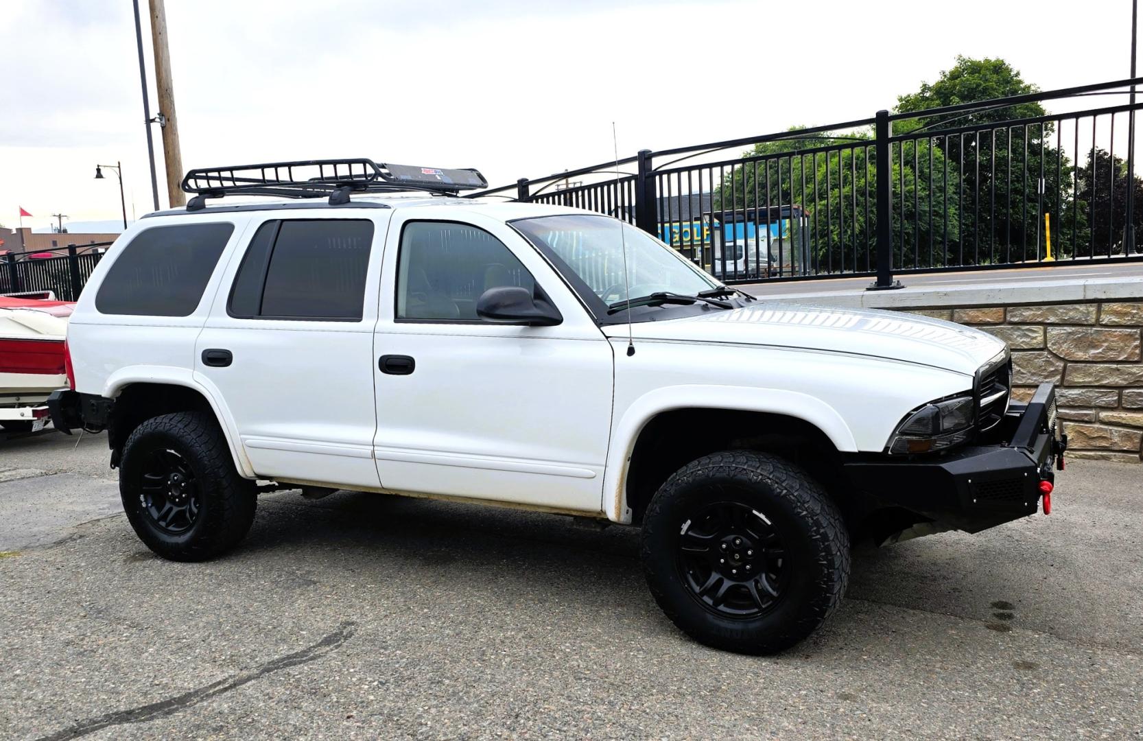 2003 White /Black Dodge Durango SLT 4WD (1D4HS48N03F) with an 4.7L V8 SOHC 16V engine, located at 450 N Russell, Missoula, MT, 59801, (406) 543-6600, 46.874496, -114.017433 - Ready to Go Four Wheeling! Excellent Running 4WD SUV. 4.7L V8 Engine. Automatic Transmission. Aftermarket Front and rear Bumper. Racing Front Seats. 3rd Row Seating. Aftermarket Stereo with Add On Touch Screen. Bluetooth. Air Conditioning. Power Windows and Locks.- Photo#0