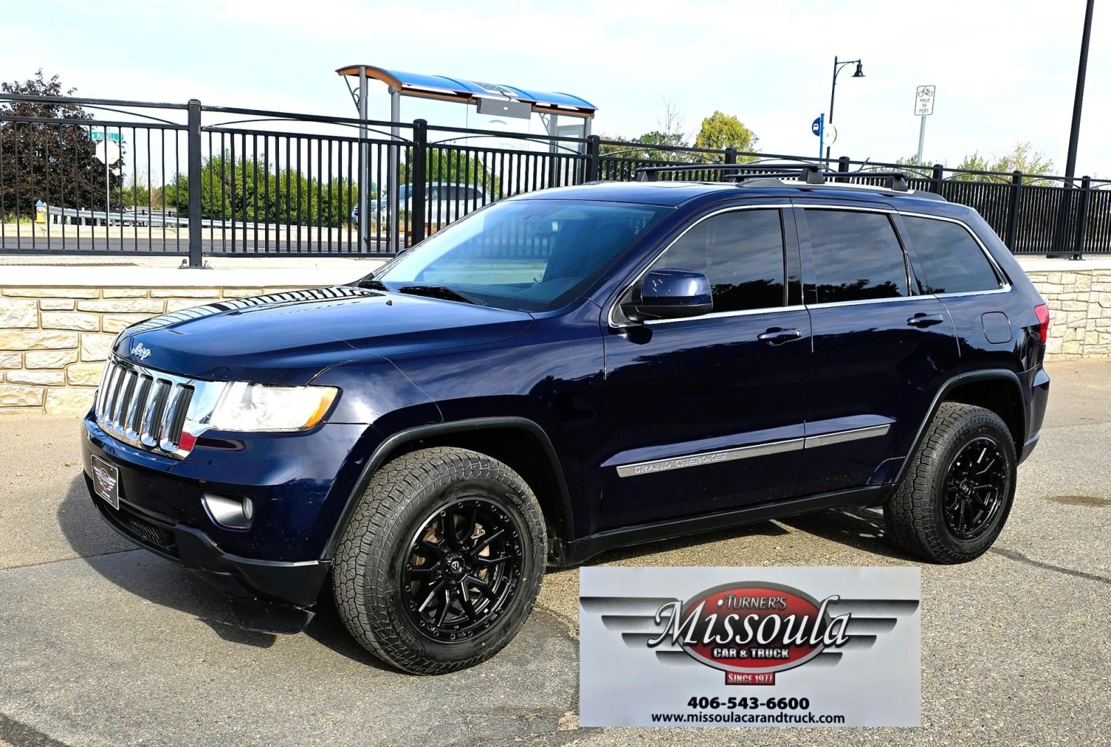 2012 Blue /Black Jeep Grand Cherokee Laredo 4WD (1C4RJFAT3CC) with an 5.7L V8 OHV 16V engine, 5-Speed Automatic transmission, located at 450 N Russell, Missoula, MT, 59801, (406) 543-6600, 46.874496, -114.017433 - Classy 4WD SUV. 5.7L Hemi V8 Engine. Automatic Transmission. Huge Panoramic Sunroof. Remote Ignition. Touch Screen Stereo. Bluetooth Audio and Phone Connection. Navigation. Air. Cruise. Tilt. Power Windows and Locks. New Struts and Shocks. Nice Aftermarket Wheels with like New Tires.- Photo#1