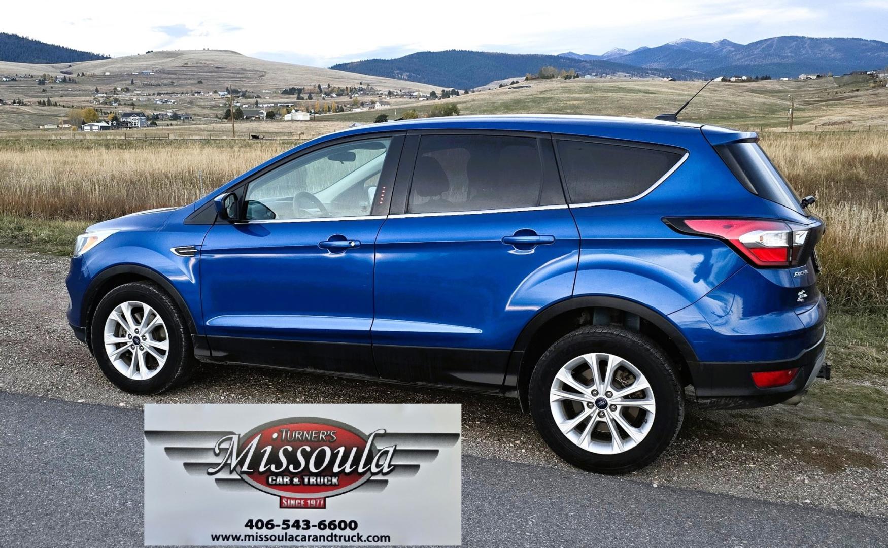 2017 Blue /Gray Ford Escape SE 4WD (1FMCU9GD9HU) with an 1.5L L4 DOHC 16V engine, 6A transmission, located at 450 N Russell, Missoula, MT, 59801, (406) 543-6600, 46.874496, -114.017433 - Cute little One Owner AWD SUV with Goodyear Tires all around. Ready for Winter Roads or Summer Cruising. Fuel Economy Friendly 1.4L I4 Engine. 6 Speed Automatic Transmission. Power Drivers Seat. Dual Climate Control. AM FM CD Player with Bluetooth Audio and Phone Connectivity. Backup Camera. Has a s- Photo#2