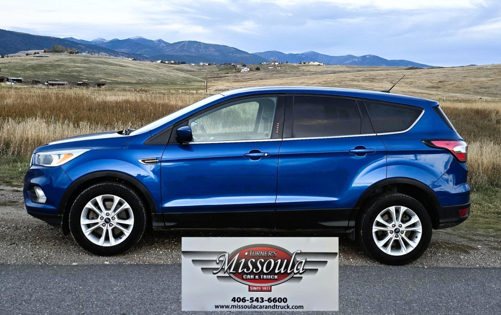 2017 Blue /Gray Ford Escape SE 4WD (1FMCU9GD9HU) with an 1.5L L4 DOHC 16V engine, 6A transmission, located at 450 N Russell, Missoula, MT, 59801, (406) 543-6600, 46.874496, -114.017433 - Cute little One Owner AWD SUV with Goodyear Tires all around. Ready for Winter Roads or Summer Cruising. Fuel Economy Friendly 1.4L I4 Engine. 6 Speed Automatic Transmission. Power Drivers Seat. Dual Climate Control. AM FM CD Player with Bluetooth Audio and Phone Connectivity. Backup Camera. Has a s- Photo#0