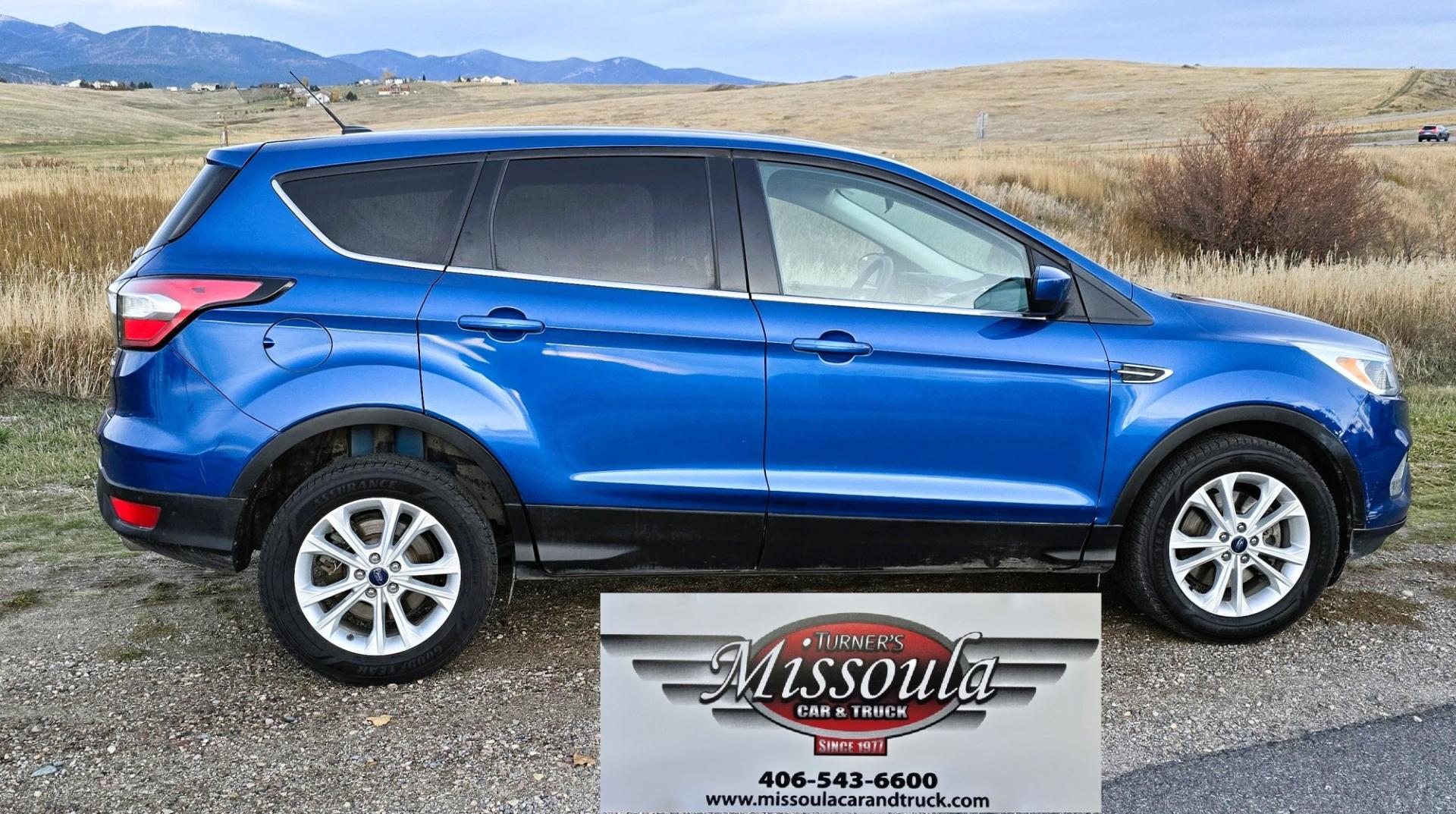 2017 Blue /Gray Ford Escape SE 4WD (1FMCU9GD9HU) with an 1.5L L4 DOHC 16V engine, 6A transmission, located at 450 N Russell, Missoula, MT, 59801, (406) 543-6600, 46.874496, -114.017433 - Cute little One Owner AWD SUV with Goodyear Tires all around. Ready for Winter Roads or Summer Cruising. Fuel Economy Friendly 1.4L I4 Engine. 6 Speed Automatic Transmission. Power Drivers Seat. Dual Climate Control. AM FM CD Player with Bluetooth Audio and Phone Connectivity. Backup Camera. Has a s- Photo#6